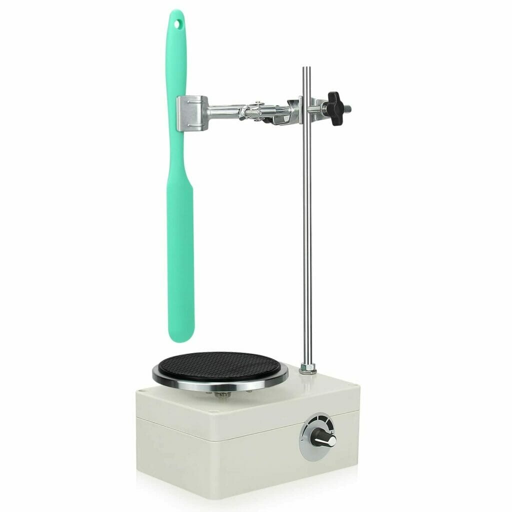 An electric machine with a green handle on top of it.