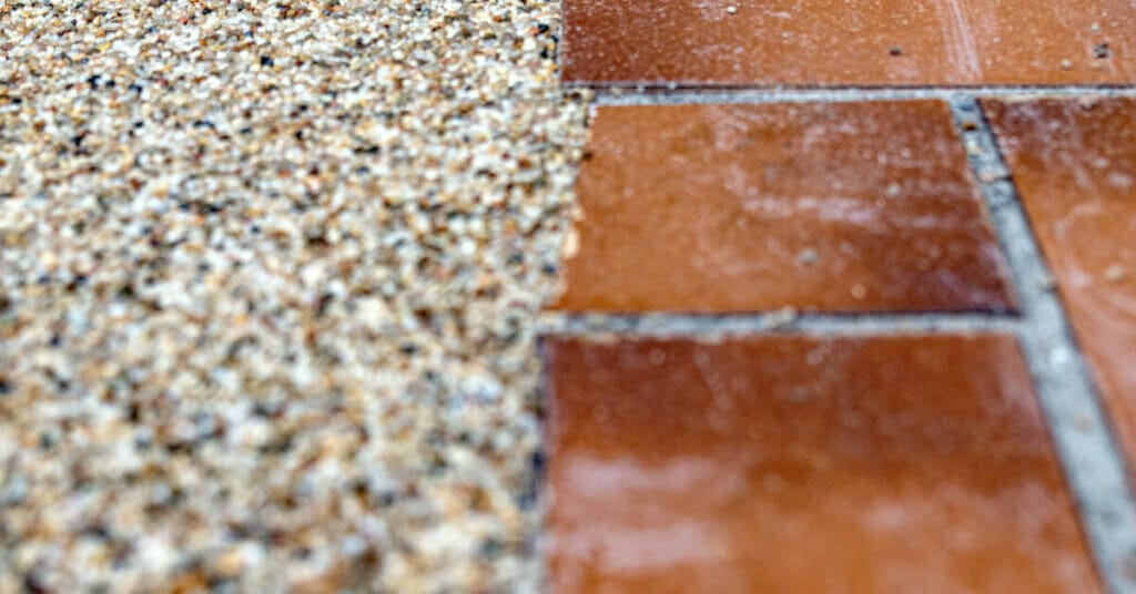 A close up of a brick walkway with sand and gravel that has been re-sealed.