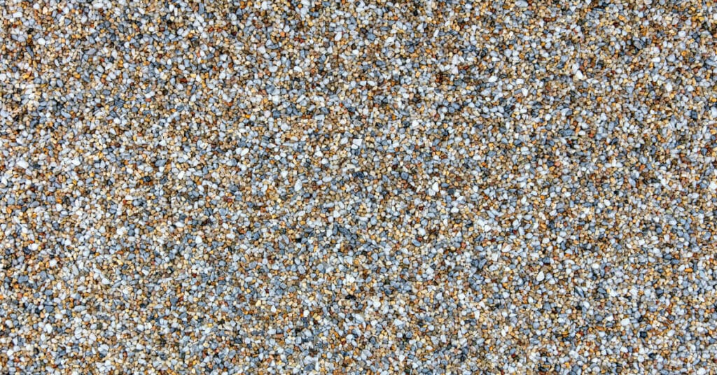 A close up image of a brown and blue pebble-stone carpet.