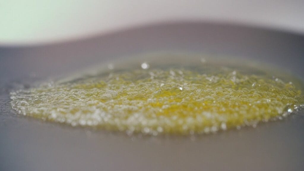 A close up of a yellow epoxy on a plate.